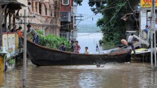 Boat in flooded street in India