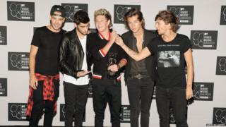 One Direction boys pose for a photograph