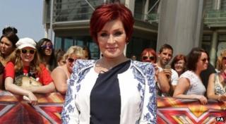 Sharon Osbourne on the red carpet surrounded by fans