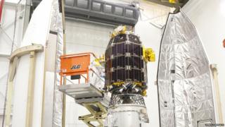 An engineer works on the LADEE device