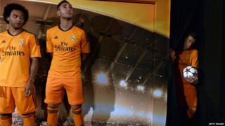 Real Madrid's Marcelo and Karim Benzema look on as Gareth Bale waits to unveil the team's new third strip