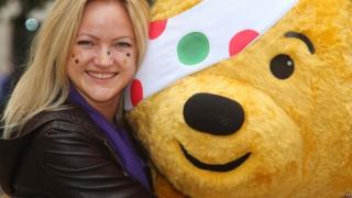 Pudsey bear and a girl with stickers on her face