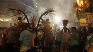 Workers prepare a dragon made of incense sticks to be paraded through the streets for the Fire Dragon Dance performance in Hong Kong in China.