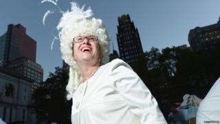 A woman in a big white wig.