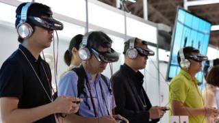 Visitors wear Japanese electronics giant Sony's new head mount display