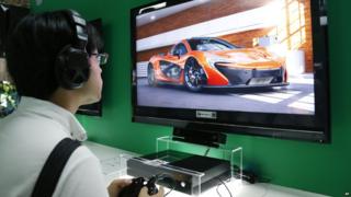 A visitor tries Microsoft Xbox One