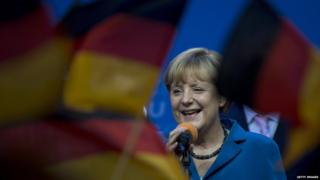 Angela Merkel surrounded by Germany flags