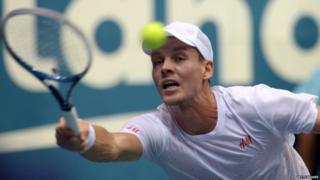 Tomas Berdych of the Czech Republic hits the ball against Gilles Simon of France during the semi-final round of the ATP Thailand Open 2013 tennis tournament in Bangkok