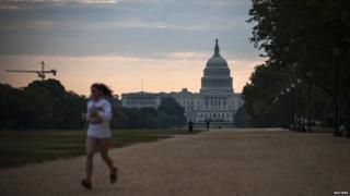 A woman jogs by the U.S. Capitol building