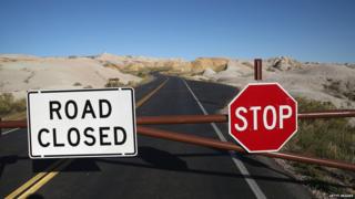 A barricade prevents visitors from entering the interior of the Badlands National Park, US.