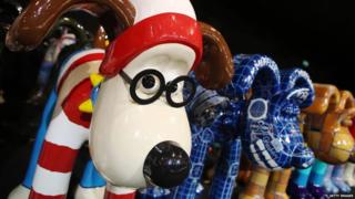 A Gromit with a stripy red and white outfit on.