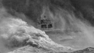 Photograph of a ferry leaving Newhaven harbour in a storm by David Lyon