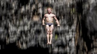 Alain Kohl of Luxembourg dives from the 27 metre platform at Maya Bay in the Andaman Sea during the final stop of the 2013 Red Bull Cliff Diving World Series.