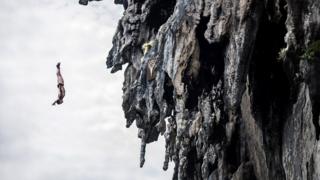 David Colturi of the USA dives from a 25 metre rock at Viking Caves in the Andaman Sea during competition on the fifth day of the final stop of the 2013 Red Bull Cliff Diving World Series