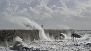 Waves crashing over the harbour in Newhaven, east Sussex.