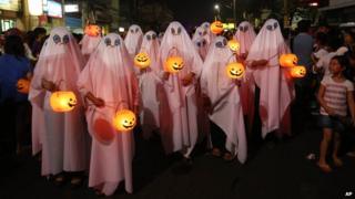 People dressed in ghost costumes