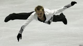 A man mid-air as he skates on ice