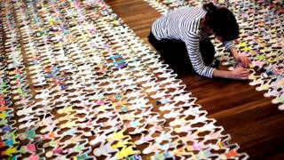 Volunteer working with paper dolls
