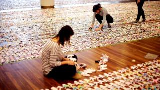 Volunteers working with paper dolls