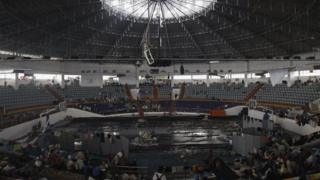 People shelter in stadium after the typhoon