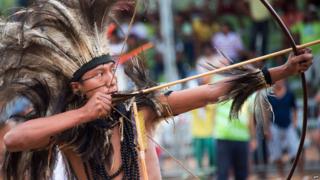 Brazilian indigenous man of the Terena tribe takes part in the bow and arrow competition