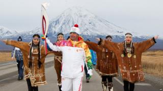 Russian torchbearer carries the Sochi 2014 torch