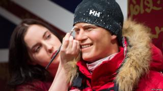 Luisa Compobassi puts finishing touches to a waxwork figure of Prince Harry in arctic clothing