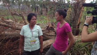 Headteacher showing Leah the damage done to the school