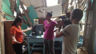 Teacher showing Leah round destroyed computer classroom