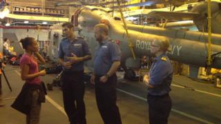 Royal Navy crew talking to Leah onboard ship