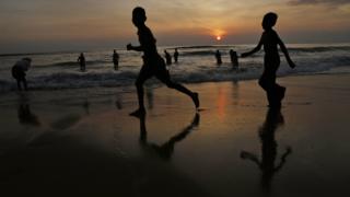 Children running on a beach.