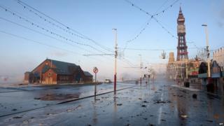 Debris from the sea is strewn across the road after a high tide in Blackpool, north west England, on December 5, 2013 as high winds hit the north of England and Scotland.
