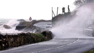 High winds and the sea batter the Antrim coast road, in County Antrim, Northern Ireland