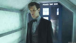 Matt Smith as the Doctor stands in front of the Tardis