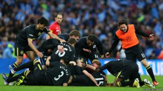 Wigan Athletic footballers celebrate on pitch