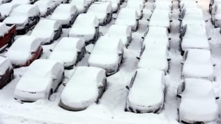 Cars are covered by snow in rental car parking lot at O'Hare International Airport in Chicago, Thursday, Jan. 2, 2014