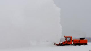 Maintenance worker Joe Ehrenberg uses an Unimog to clear snow from a ramp at the Southwest Michigan Regional Airport Thursday, Jan. 2, 2014