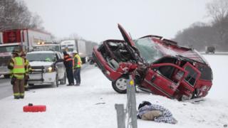 Emergency workers respond to a vehicle that slid off the road.
