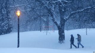 People walking through snow