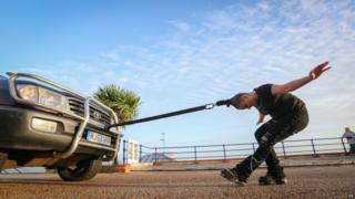 Circus performer pulls car with her hair