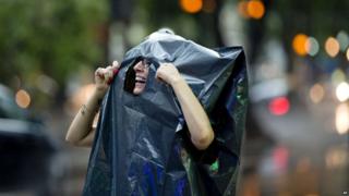 A woman wearing plastic rubbish bag