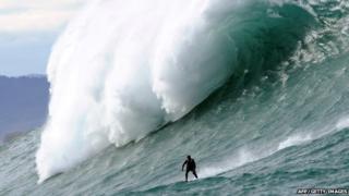 Surfer rides huge wave off French coast