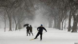 A man on cross country skis as he makes his way along the National Mall as a snow storm hits Washington January 21, 2014.