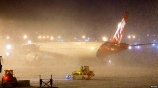 TAM airlines plane sits shrouded by snow