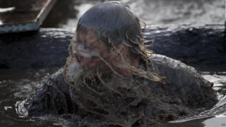 Tough Guy competitor in muddy water