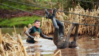 Tough Guy competitor dangles from rope