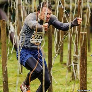 Tough Guy competitor Nicholas Woods runs through electric shocks