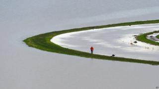Man walks along River Tone