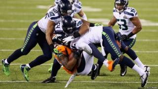 Demaryius Thomas of the Denver Broncos is tackled during Super Bowl