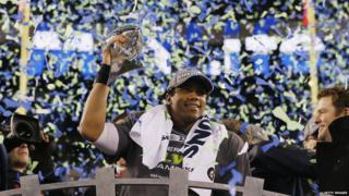 Quarterback Russell Wilson #3 of the Seattle Seahawks celebrates with the Vince Lombardi Trophy after their 43-8 victory over the Denver Broncos during Super Bowl XLVIII